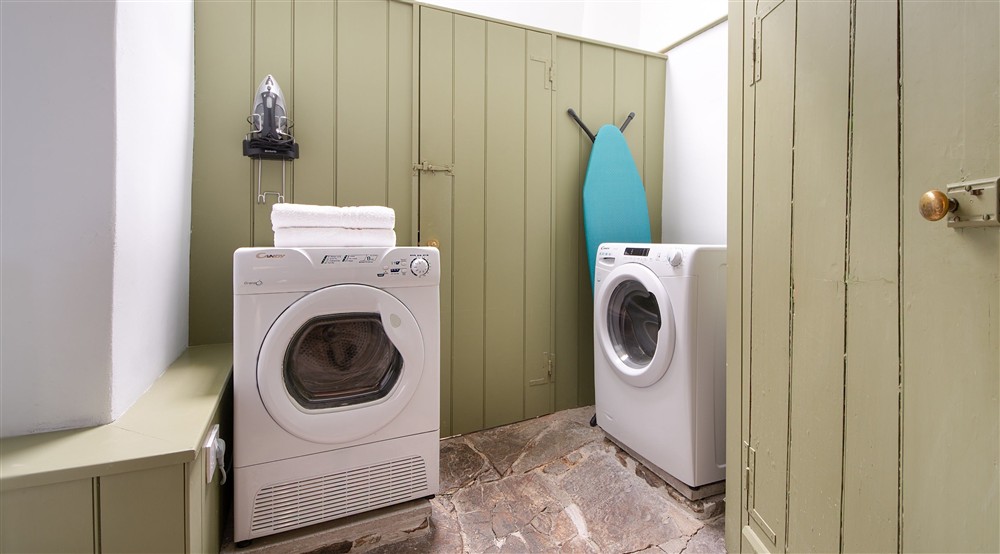 The utility room with washing machine, tumble dryer at West Challacombe Manor in West Exmoor, Devon