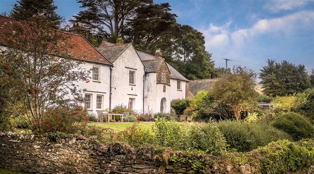 West Challacombe Manor and West Challacombe Cottage next door, with their shared garden in front, Devon at West Challacombe Manor in West Exmoor, Devon