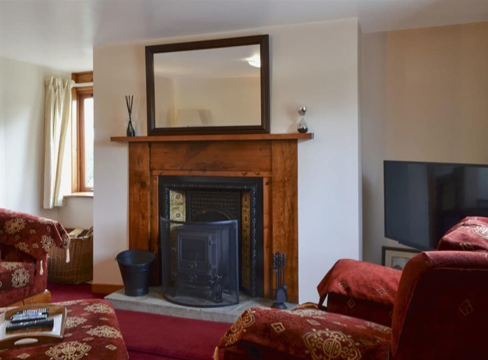 Welcoming living room with cosy wood burner at West End Cottage in Carrbridge, near Aviemore, Highlands, Inverness-Shire