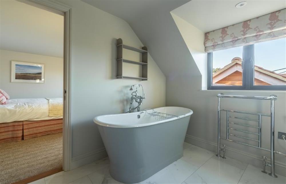 First floor: The en-suite bathroom and master bedroom at West Heath, Brancaster Staithe near Kings Lynn