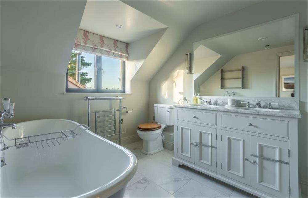 First floor: The en-suite bathroom has luxury roll-top bath  at West Heath, Brancaster Staithe near Kings Lynn