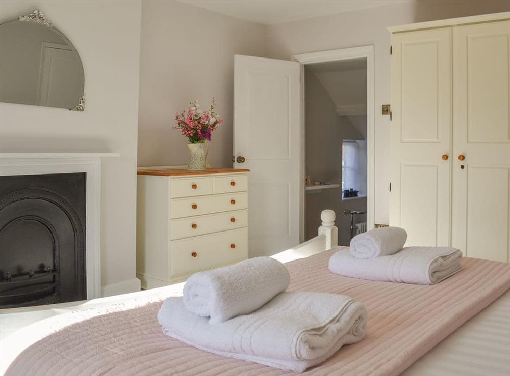 Bedroom with steps down to en-suite bathroom at West House Farm in Muston, near Filey, North Yorkshire