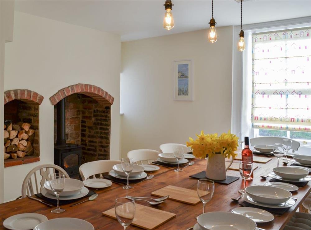 Grand dining area with wood burner at West House Farm in Muston, near Filey, North Yorkshire