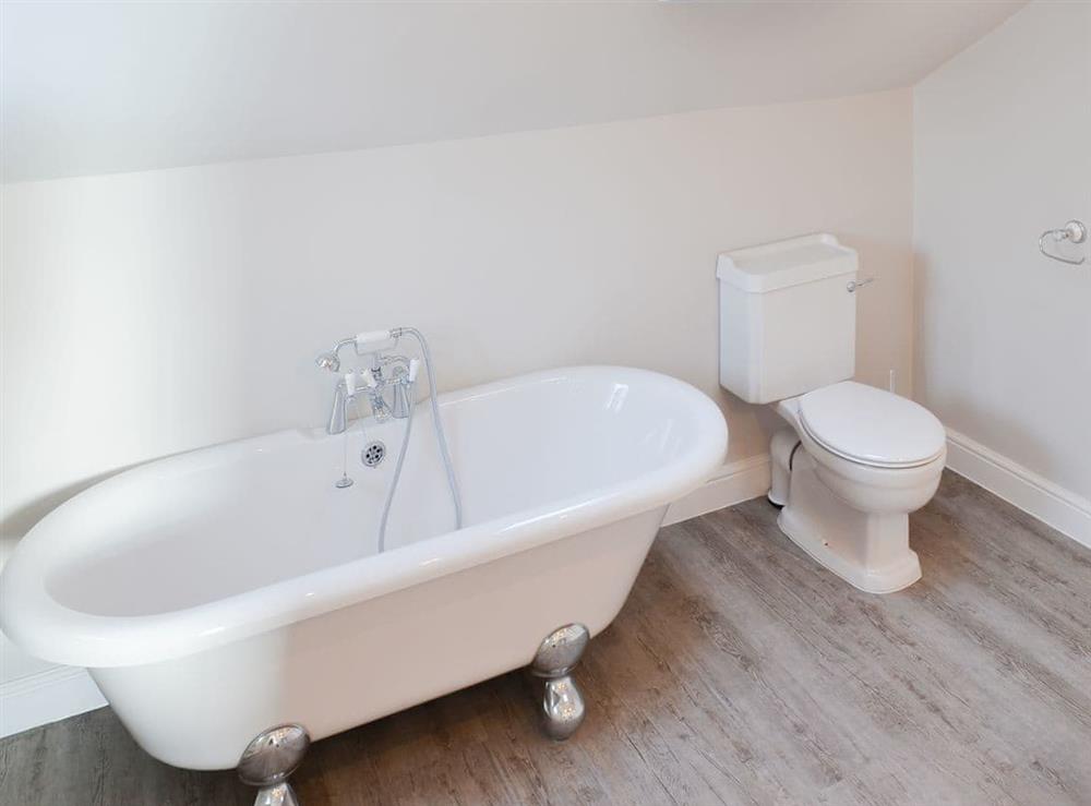 Standalone roll top bath with telephone style shower attachment at West House Farm in Muston, near Filey, North Yorkshire