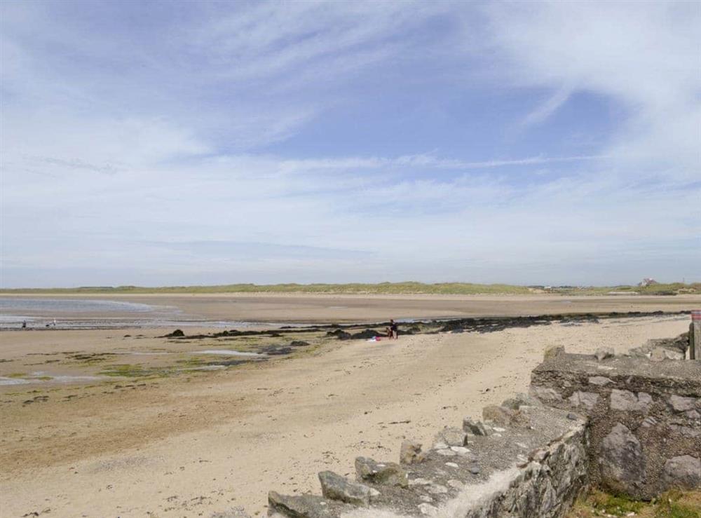 Wide sandy beach at the bottom of the garden at West Lawn in Rhosneigr, Anglesey., Gwynedd