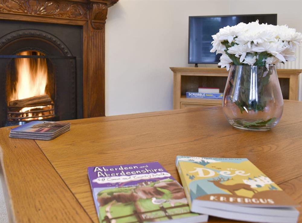 Welcoming living room with open fire at West Lodge in Banchory, Kincardineshire