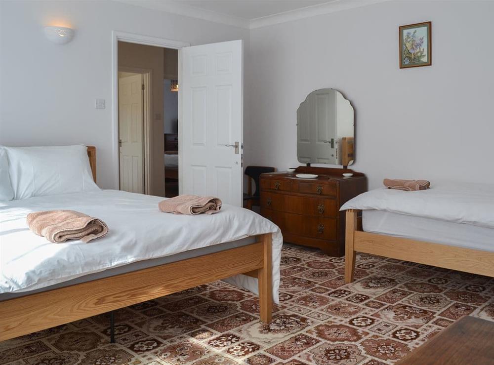 Bedroom with double and single beds at The Old Creamery, 
