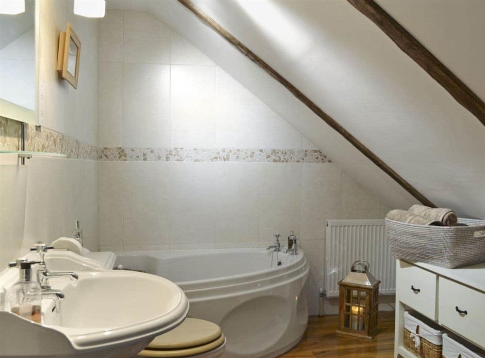 En-suite bathroom with Jacuzzi corner bath at West Wood Barn in Sutton-upon-Derwent, Nr York., North Yorkshire