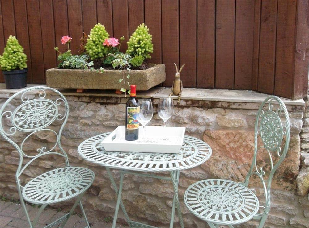 Paved patio area with outdoor furniture at West Wood Hideaway in Wrelton, near Pickering, North Yorkshire
