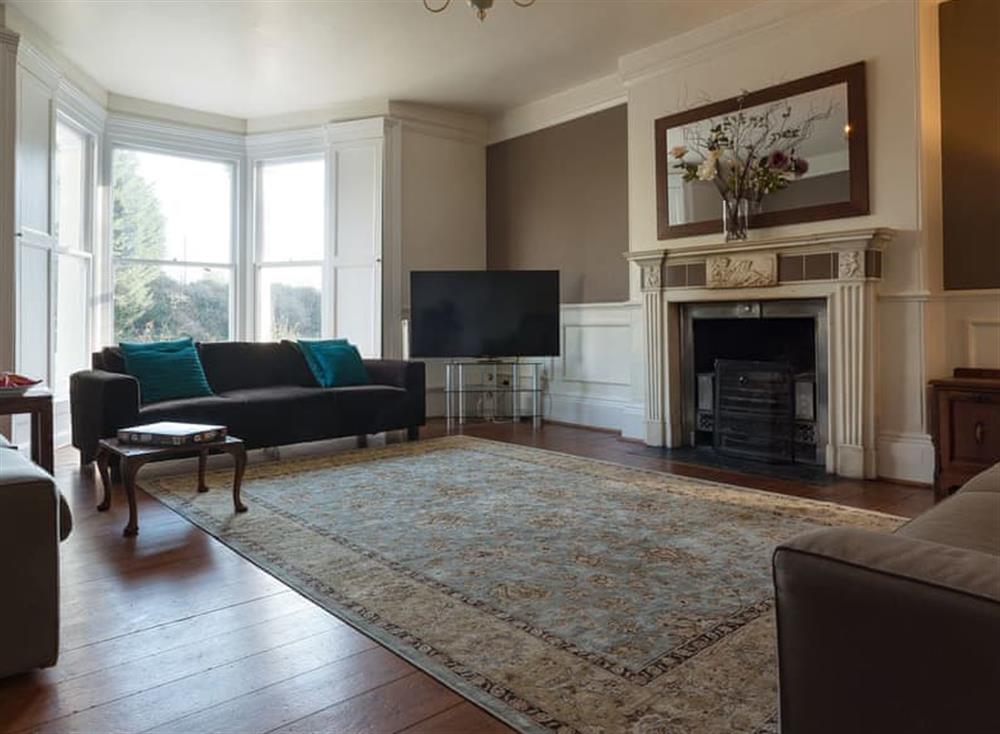 Living room with open fire at Westcott House in Rockbeare, near Exeter, Devon