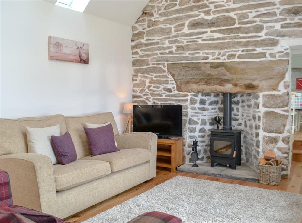 Characterful living room with cosy wood burner at Wester Laggan Cottage in Dulnain Bridge, near Grantown-on-Spey, Highlands, Morayshire