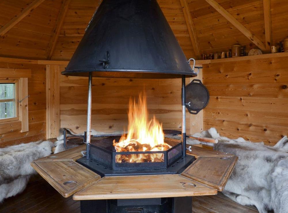 Finnish timber hobbit house with barbecue and firepit