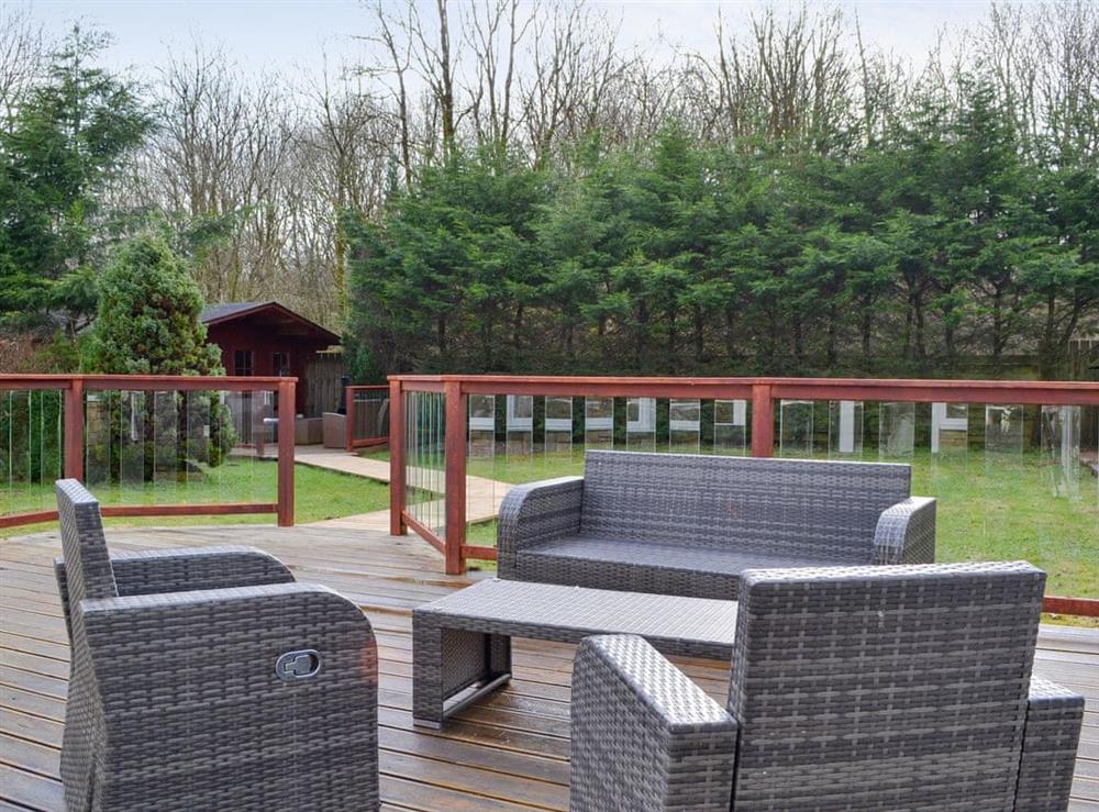 Outdoor furniture on the decked patio at Western Fells Cottage in Rowrah, near Frizington, Cumbria