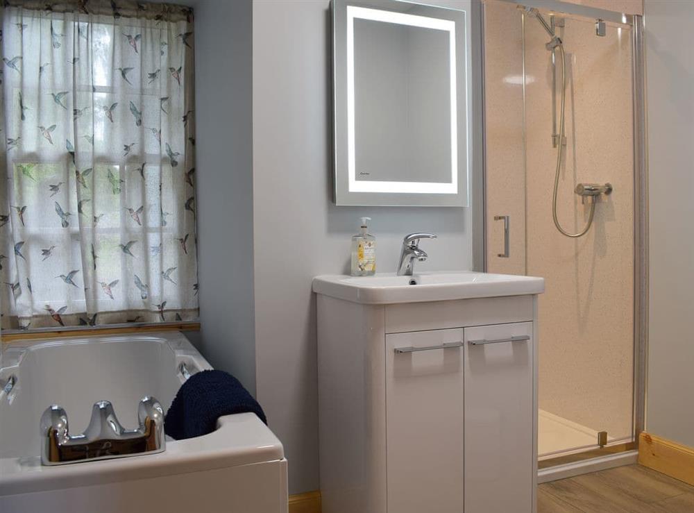 Bathroom with bath and shower cubicle at The Old Stables at Westerton, 
