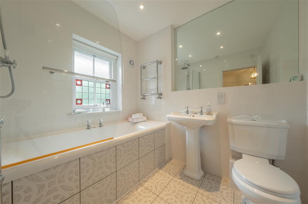 First Floor: Family bathroom including bath with shower over,  wash basin and WC at Westfield, Plymouth