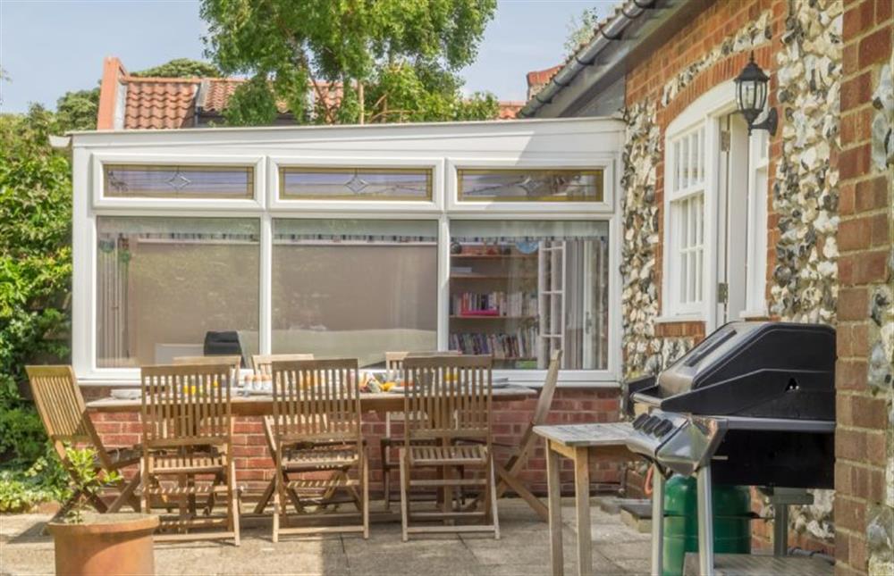 Patio with outdoor table, seating and barbecue