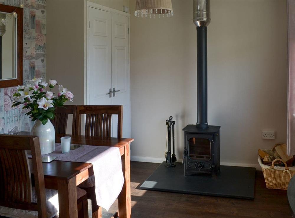 Dining area with wood burner at Westville by the Stream in Rosecraddoc, near Liskeard, Cornwall