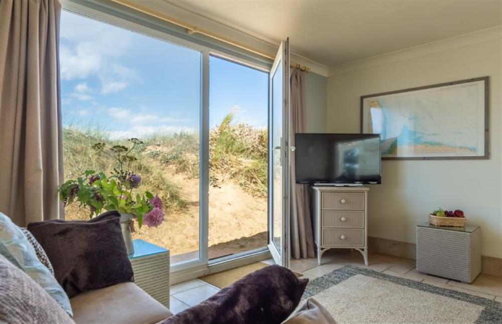 Westward Ho: Sitting room with door to the dunes at Westward Ho, Heacham near Kings Lynn