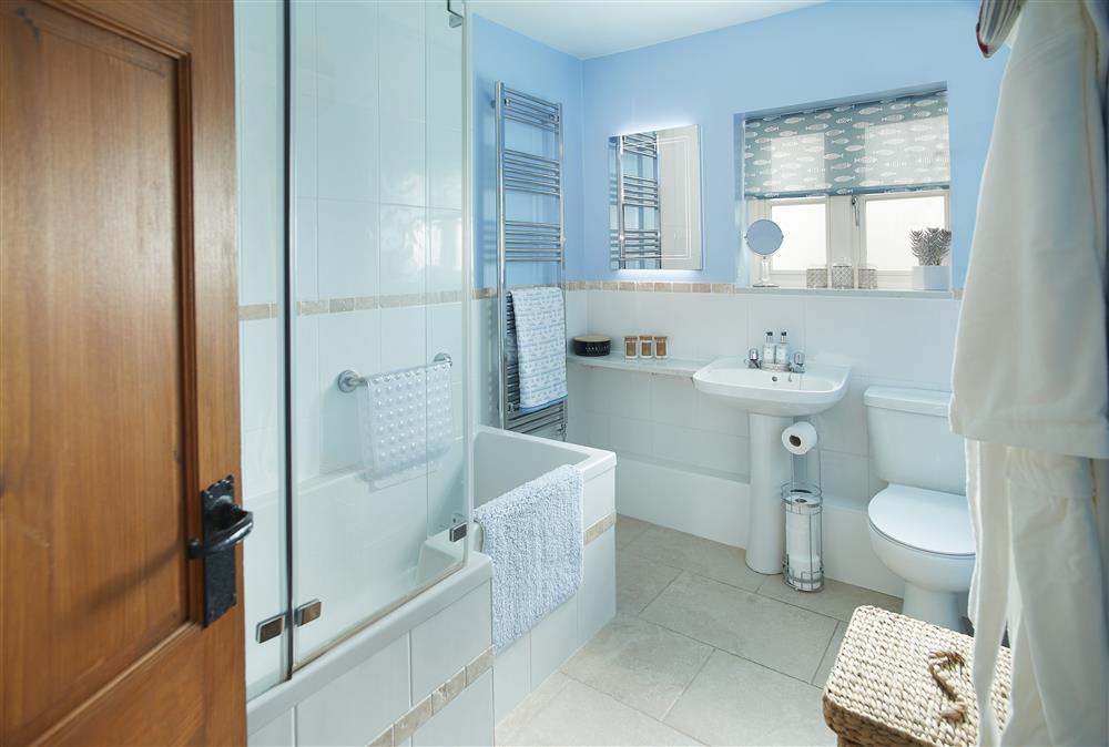Bathroom with bath and shower over at Wharf Cottage, Wootton Wawen
