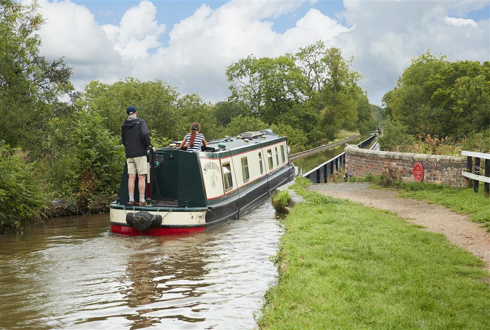 Narrowboat gracefully passing by at Wharf Cottage, Wootton Wawen