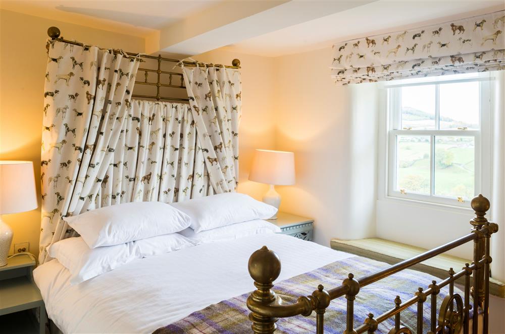 Bedroom one with a 5’ king-size bed at Wharfe View Cottage, Skipton