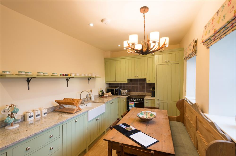 The farmhouse style kitchen, with dining table seating six guests at Wharfe View Cottage, Skipton
