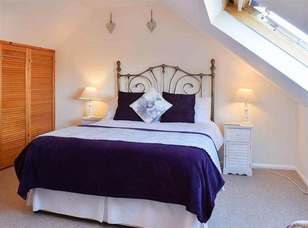 Relaxing bedroom with antique style bed at What A View! in Whitby, North Yorkshire