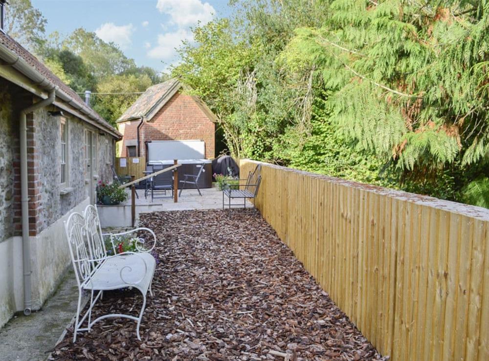 Small enclosed gravelled garden with patio, garden furniture and BBQ at Whatley Lodge in Winsham, near Chard, Somerset, England