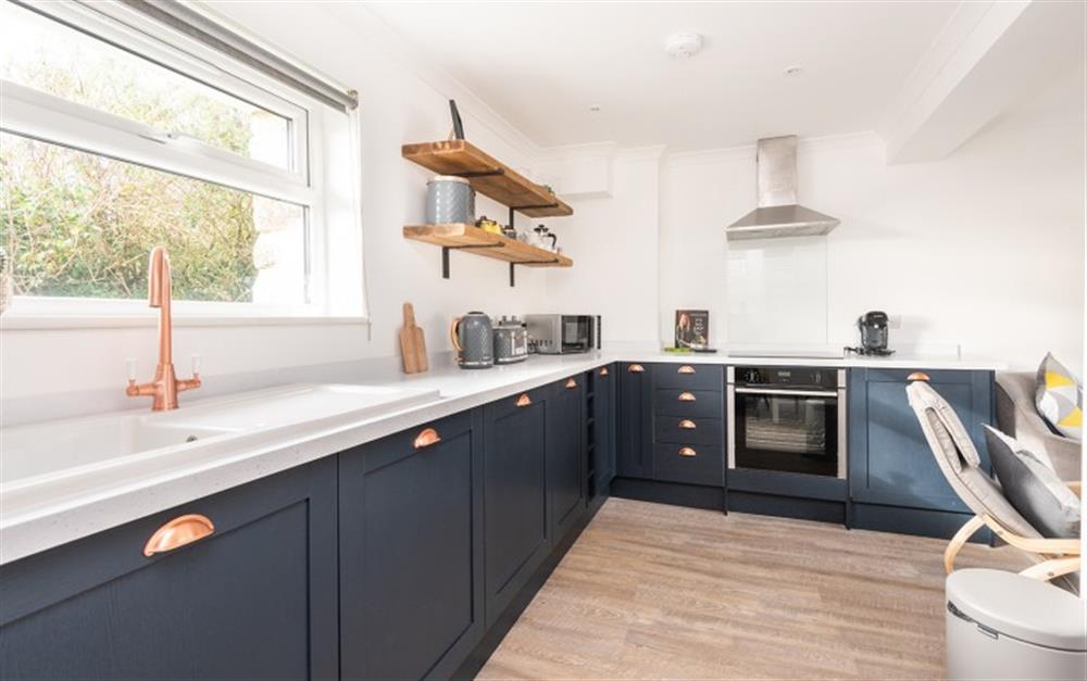 This modern kitchen has lots of cupboard space. at Wheal Charlotte Cottage in Marazion
