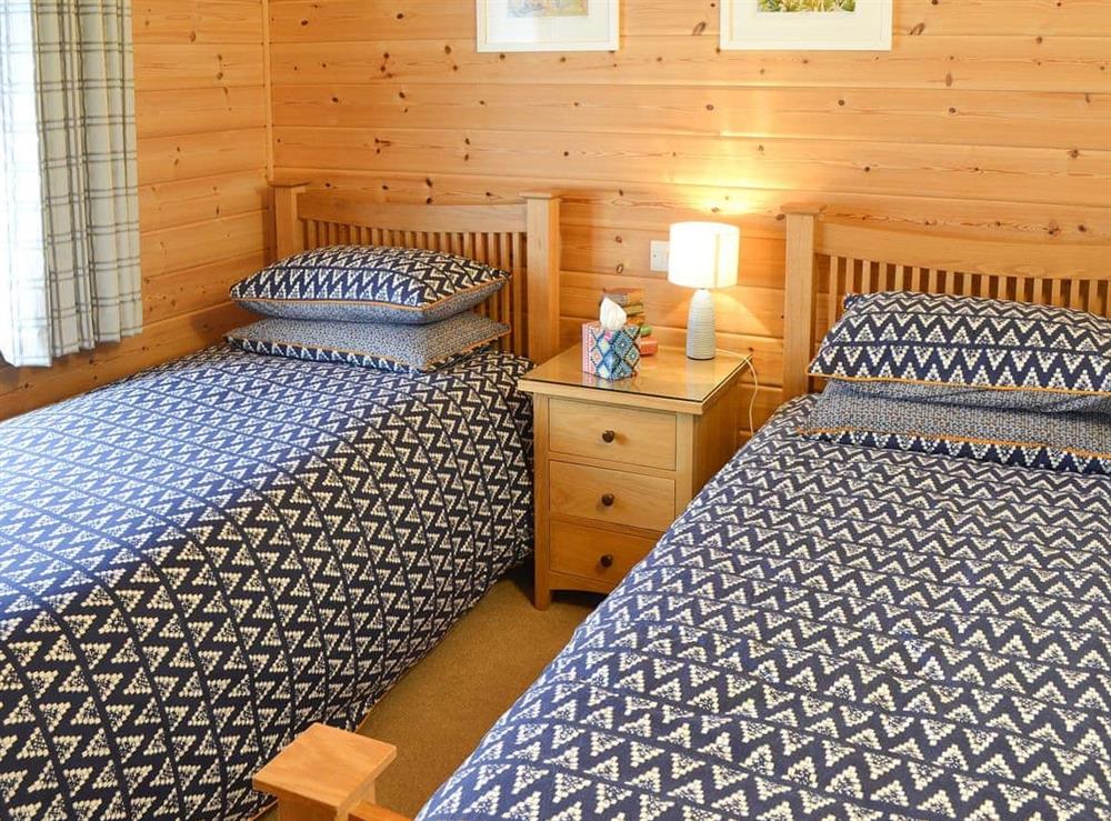 Pretty twin bedroom at Wheal Metal Lodge in Poldown, near Helston, Cornwall