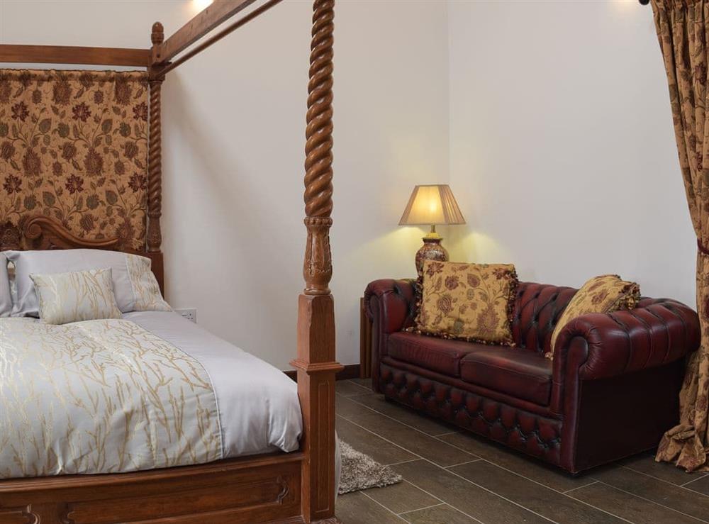 Four poster bedroom with en-suite bathroom (photo 2) at Wheelwright Barn in Ferryside, near Carmarthen, Dyfed
