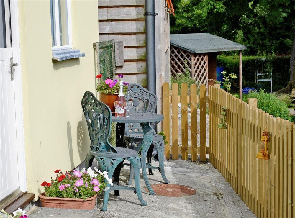 Patio with furniture at Wheelwright Cottage in Beaworthy, Devon