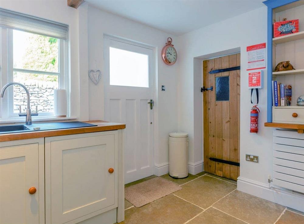 Kitchen with access to rear garden at Whibberley Cottage in Ashford-in-the-Water, near Bakewell, Derbyshire