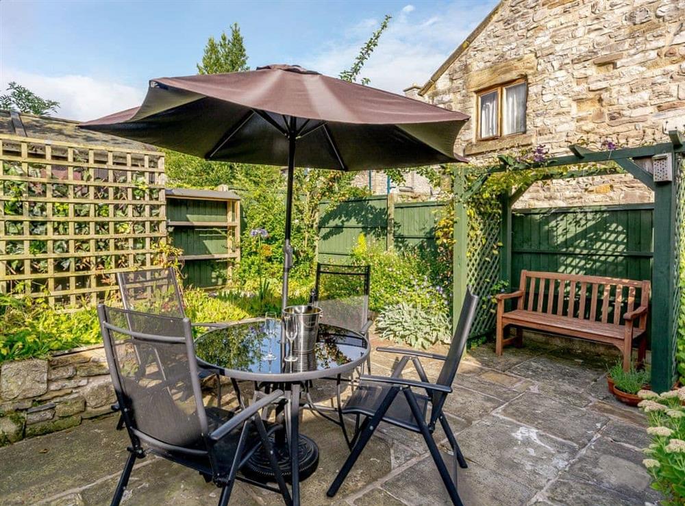 Outdoor seating area on the patio at Whibberley Cottage in Ashford-in-the-Water, near Bakewell, Derbyshire