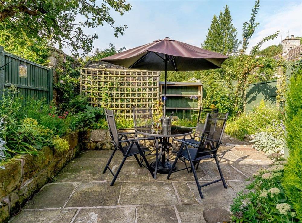 Paved patio area with outdoor furniture at Whibberley Cottage in Ashford-in-the-Water, near Bakewell, Derbyshire