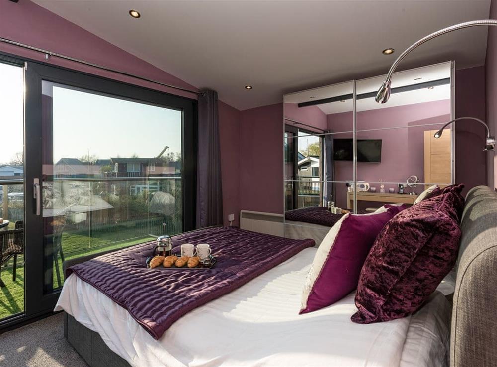 Double bedroom with balcony at Whispering Reeds in Horning, near Wroxham, Norfolk