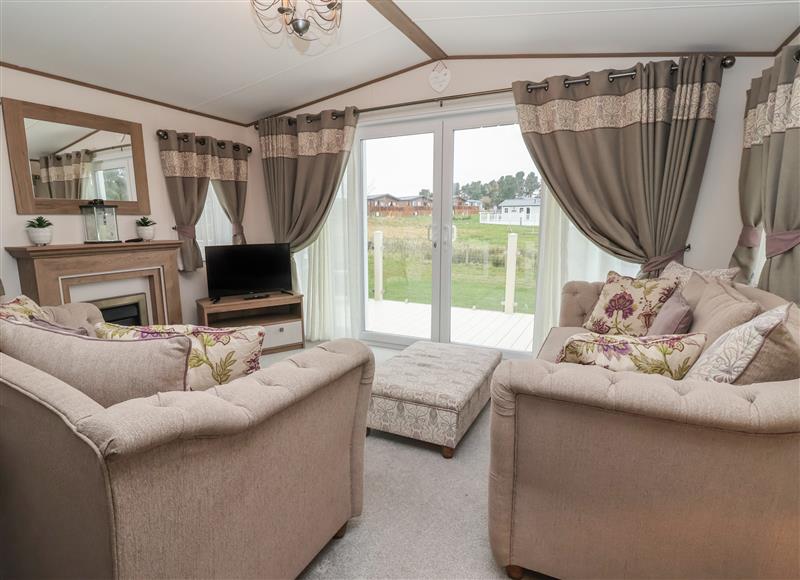 Relax in the living area at Whispering Willows, Cayton Bay