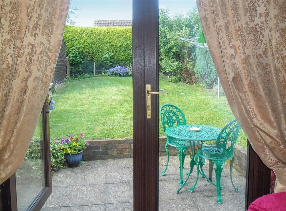 Enclosed, lawned garden with patio at White Cottage in Hemingby, near Horncastle, Lincolnshire