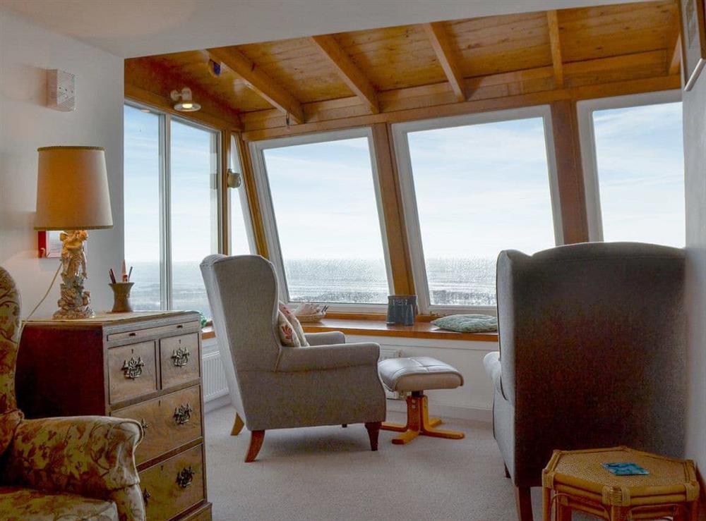 Living room with large windows with sea views at White Cottage in Lower Largo, near Leven, Fife