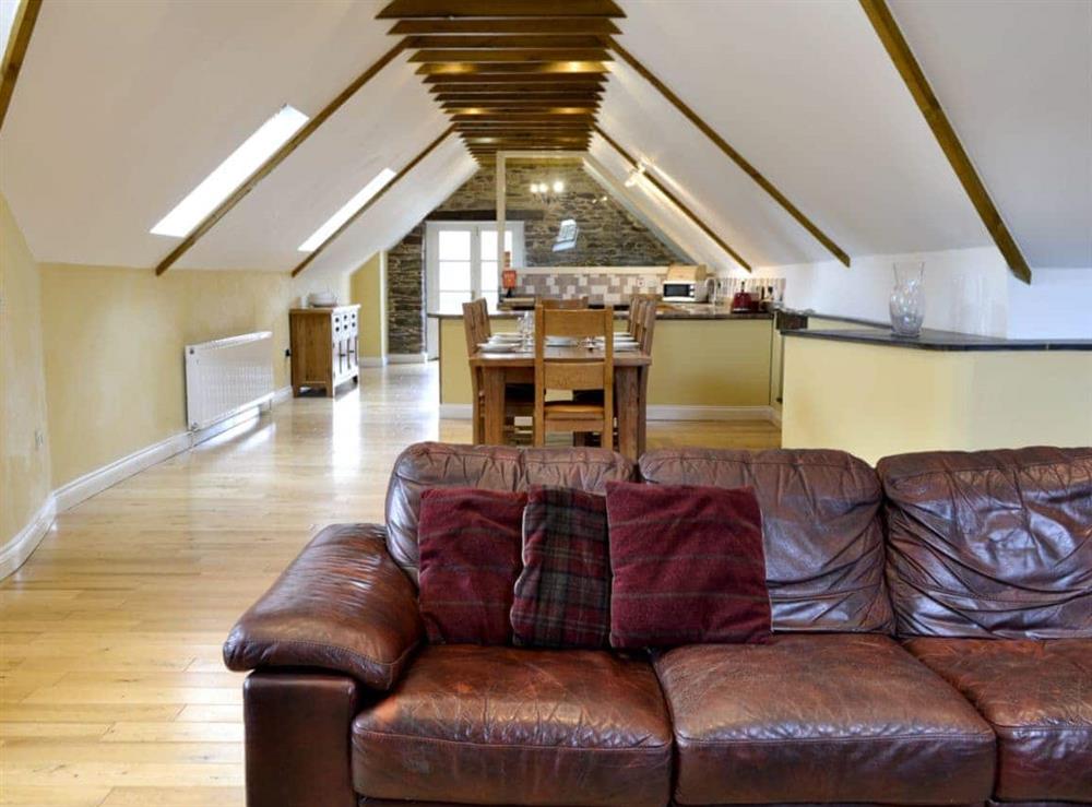 Open plan living space at White Dove Barn in Wembury, Devon