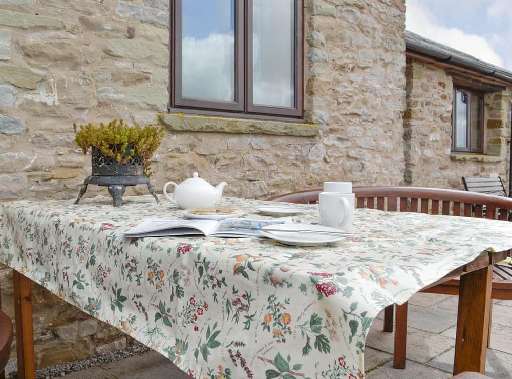 Paved patio with outdoor furniture at White Hill Farm Cottage in Wonastow, near Monmouth, Monmouthshire, Gwent