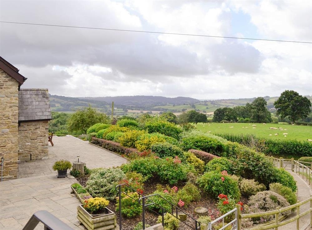 View over the patio and gardens at White Hill Farm Cottage in Wonastow, near Monmouth, Monmouthshire, Gwent