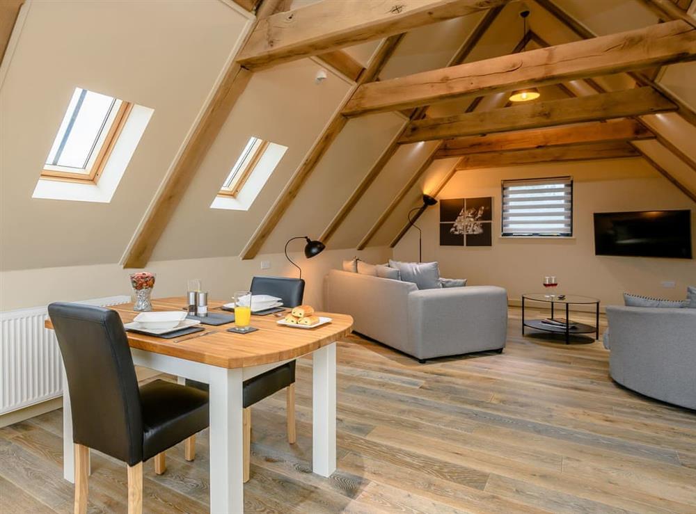 Open plan living space with vaulted ceiling at Hales Barn, 