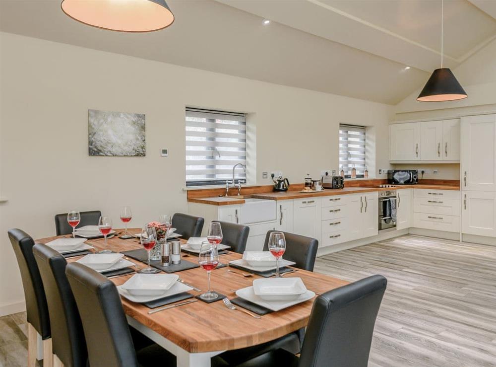 Dining area and adjacent kitchen at Holton Barn, 