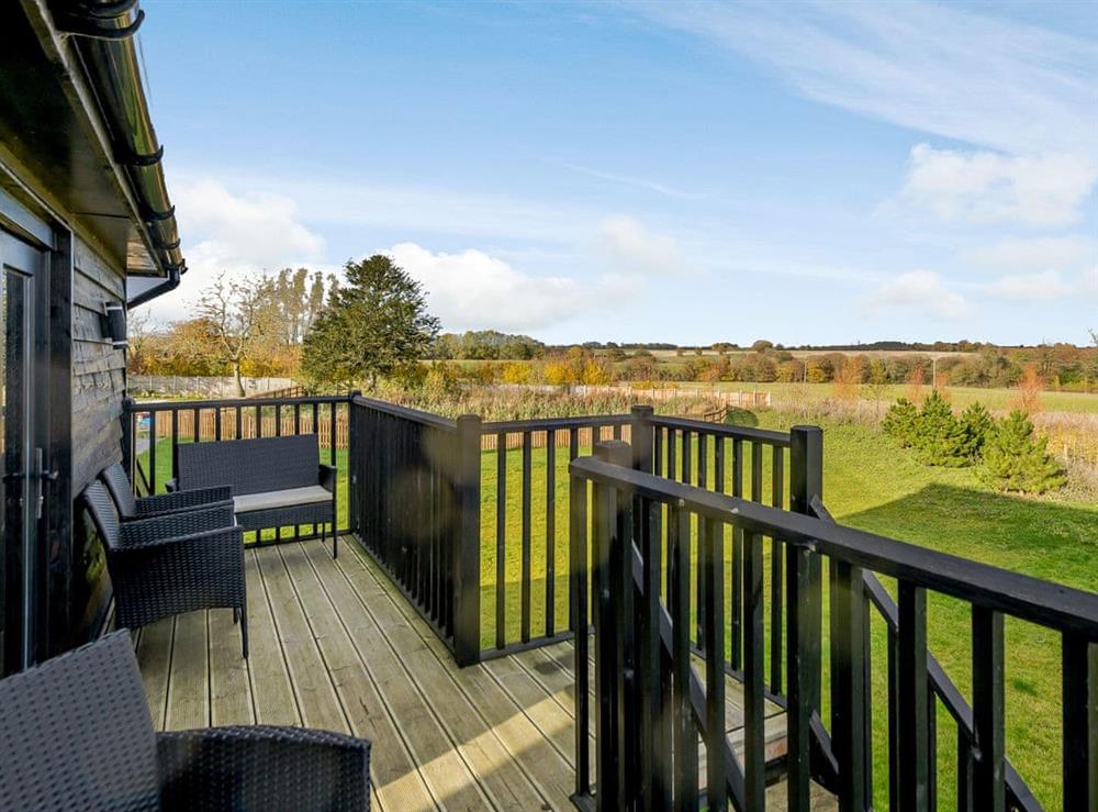 Balcony with outdoor furniture and rural views at Yoxford Barn, 