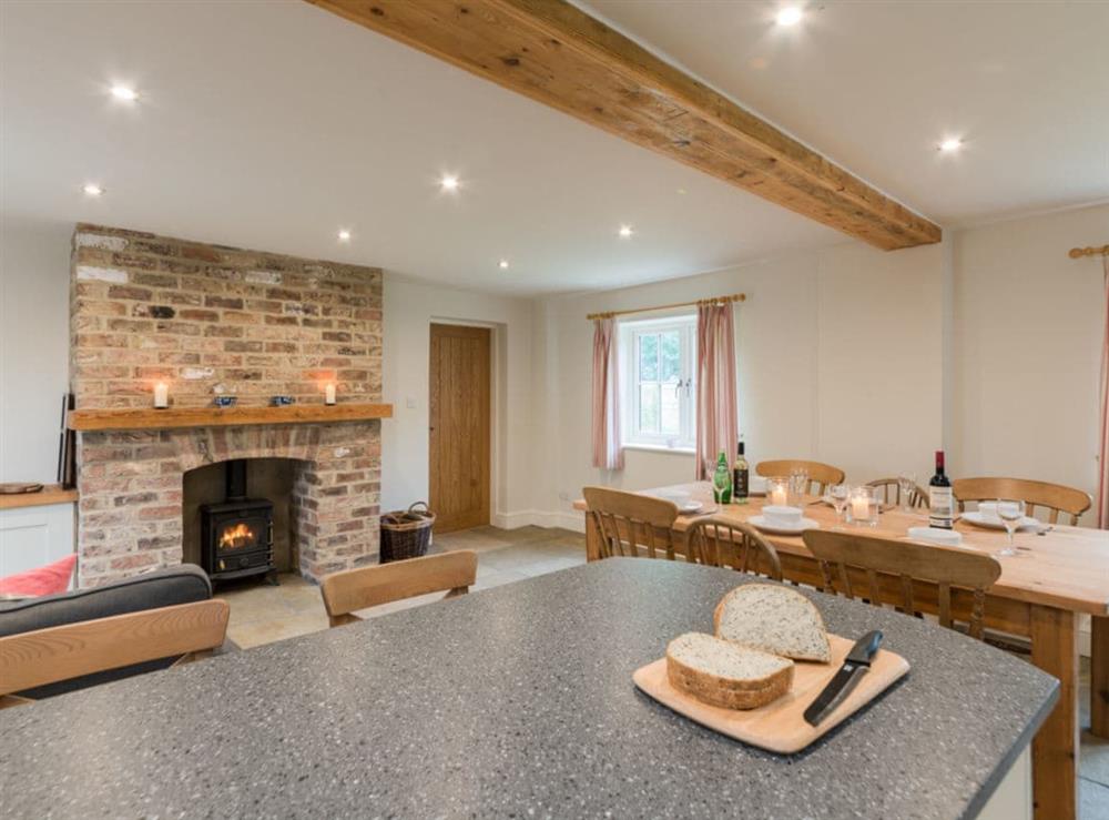 Open plan living space with exposed brickwork and a well-equipped kitchen and dining area (photo 3) at White Lodge Cottage in Carlton Miniott, near Thirsk, North Yorkshire