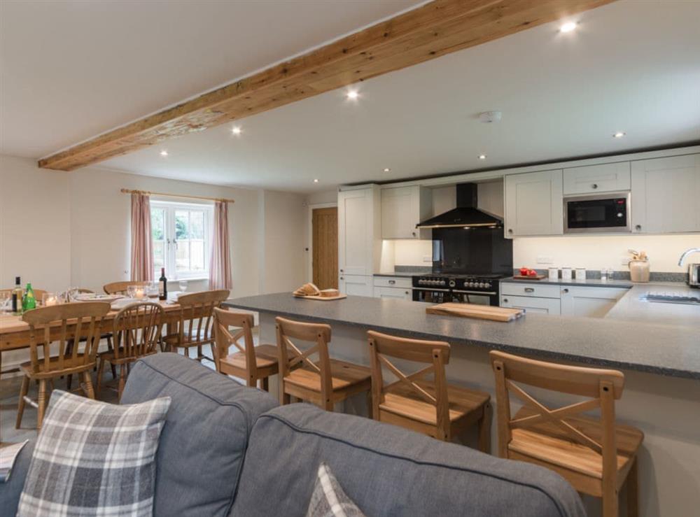 Open plan living space with exposed brickwork and a well-equipped kitchen and dining area (photo 4) at White Lodge Cottage in Carlton Miniott, near Thirsk, North Yorkshire