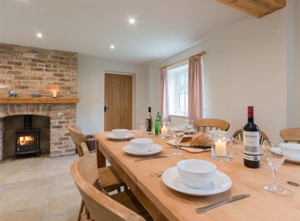 Open plan living space with exposed brickwork and a well-equipped kitchen and dining area at White Lodge Cottage in Carlton Miniott, near Thirsk, North Yorkshire