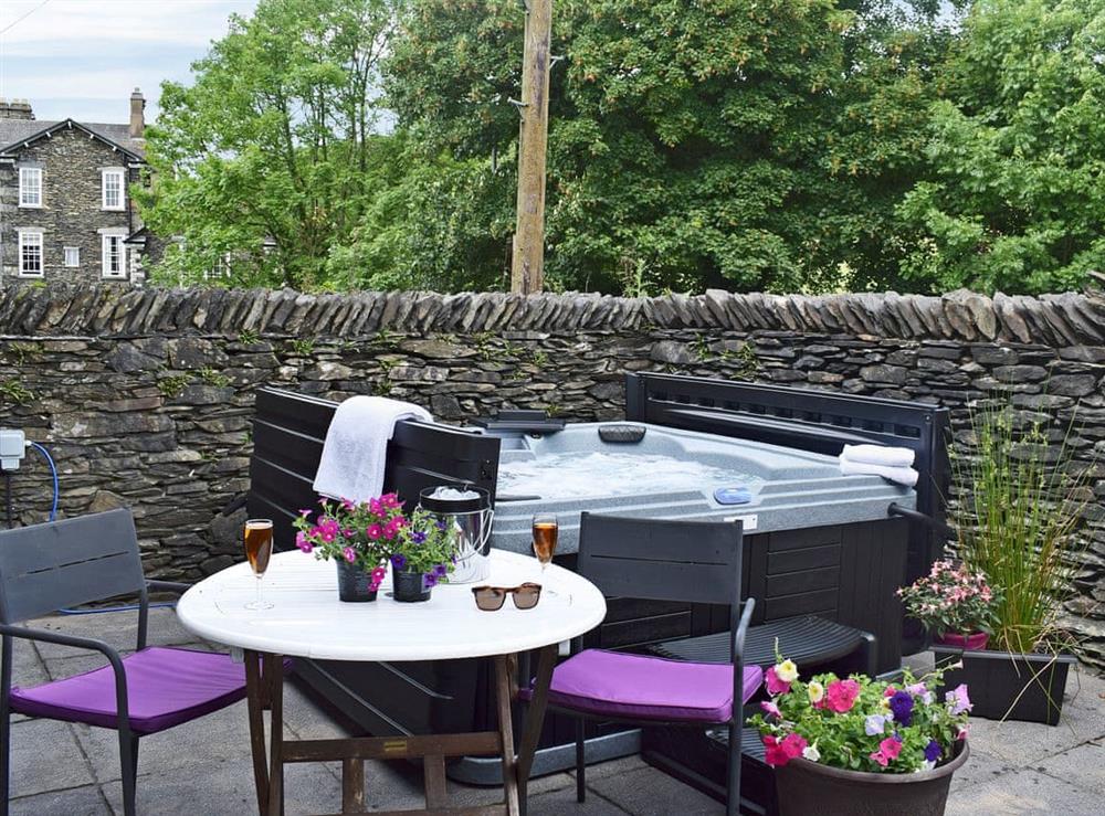 Inviting hot tub in private rear courtyard (photo 2) at White Moss in Windermere, Cumbria