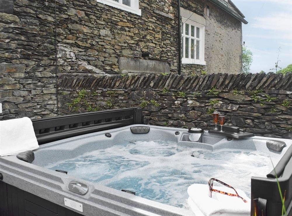 Inviting hot tub in private rear courtyard (photo 3) at White Moss in Windermere, Cumbria